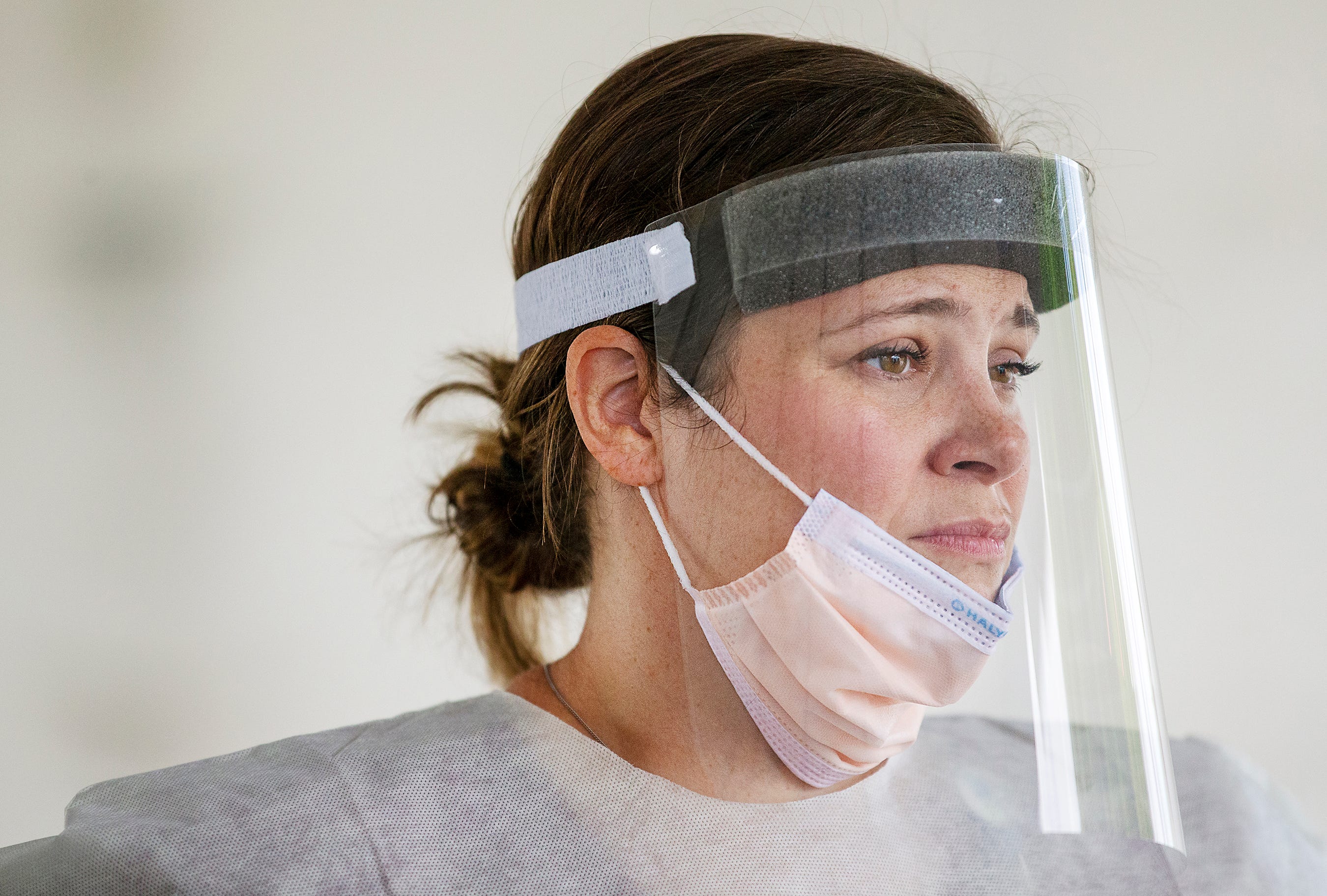 After comforting a woman she swabbed for COVID-19 testing, registered nurse Jenna Puckett takes a momentary rest before resuming testing at a mobile site in Cape Coral, Florida. "She was afraid and overwhelmed," Puckett said of the woman she tested. "She just needed someone to listen."