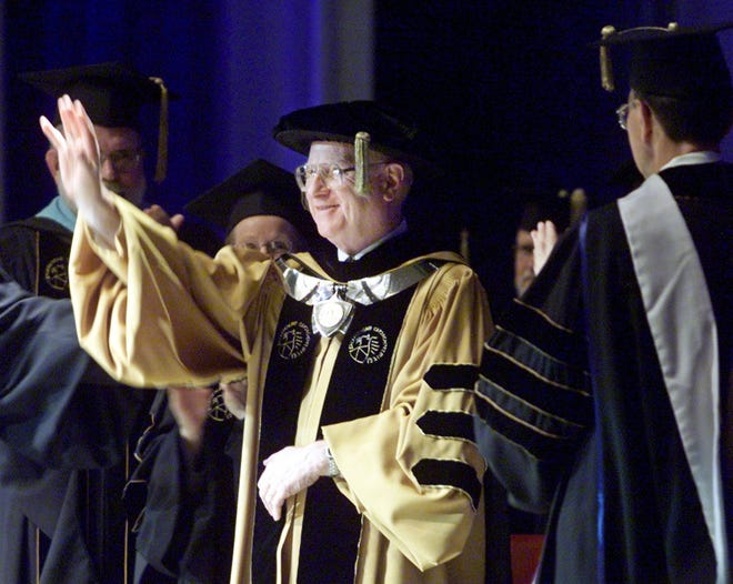 Purdue University president Steven Beering waves during the Purdue summer commencement, August 6, 2000 in West Lafayette, Ind. The summer commencement marked the final graduation for departing president Steven Beering.
