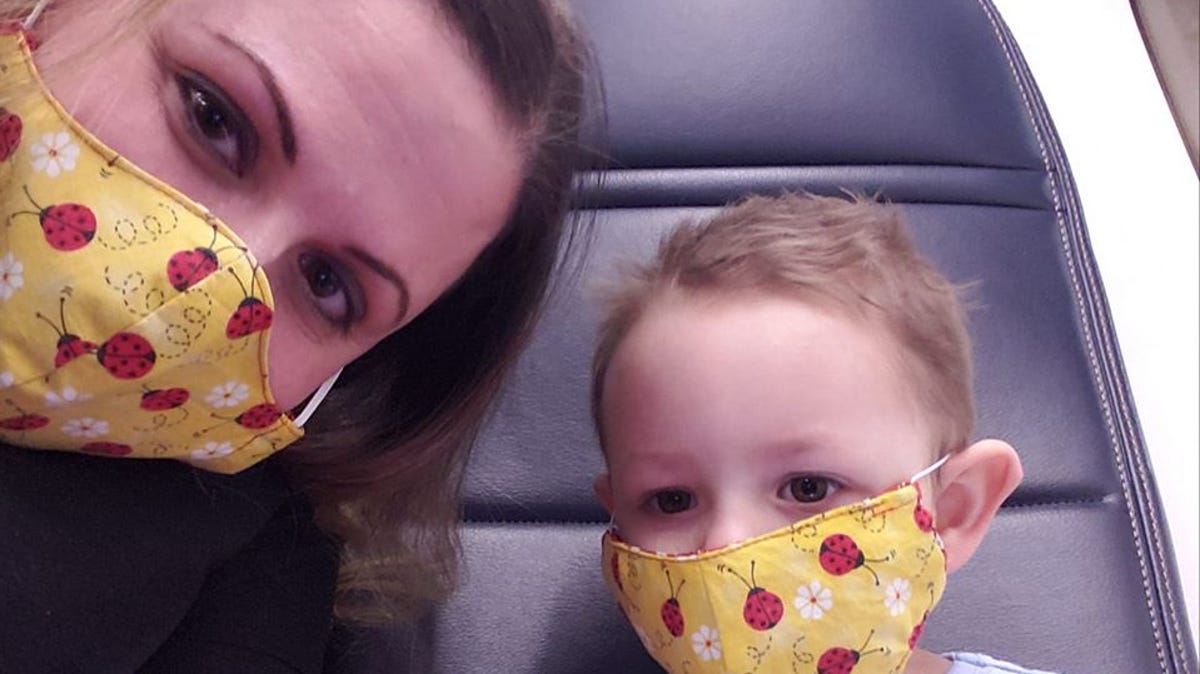 Meghan Hoskins and her daughter, Jojo, 2, on an Alaska Airlines flight to  Seattle in early February. The Montana family is still flying during the coronavirus crisis because Jojo receives chemotherapy treatment at Seattle Children's Hospital.