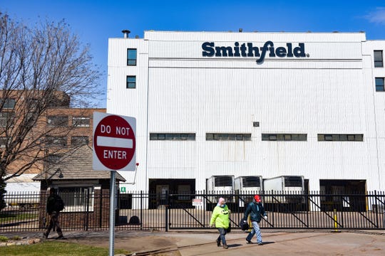 Smithfield Foods, Inc. employees wear masks as they leave at the end of their shift on Wednesday, April 8, at the food processing plant in Sioux Falls. 