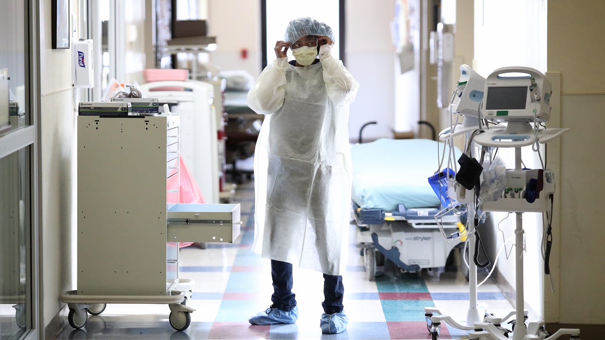 Nurses in the emergency department of MedStar St. Mary's Hospital don personal protective equipment before entering the room of a patient suspected of having coronavirus April 8 in Leonardtown, Md.