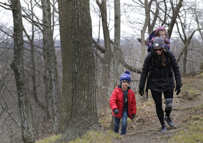 Bri Schramm hikes with her children Jax, 7, left, and Emersyn, 2, along the Red Bird Trail at High Cliff State Park Thursday, April 9, 2020, in Sherwood, Wis. The Schramms are from Green Bay.