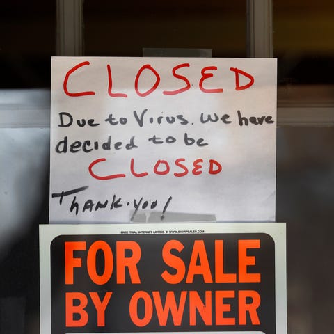 "For Sale By Owner" and "Closed Due to Virus" sign