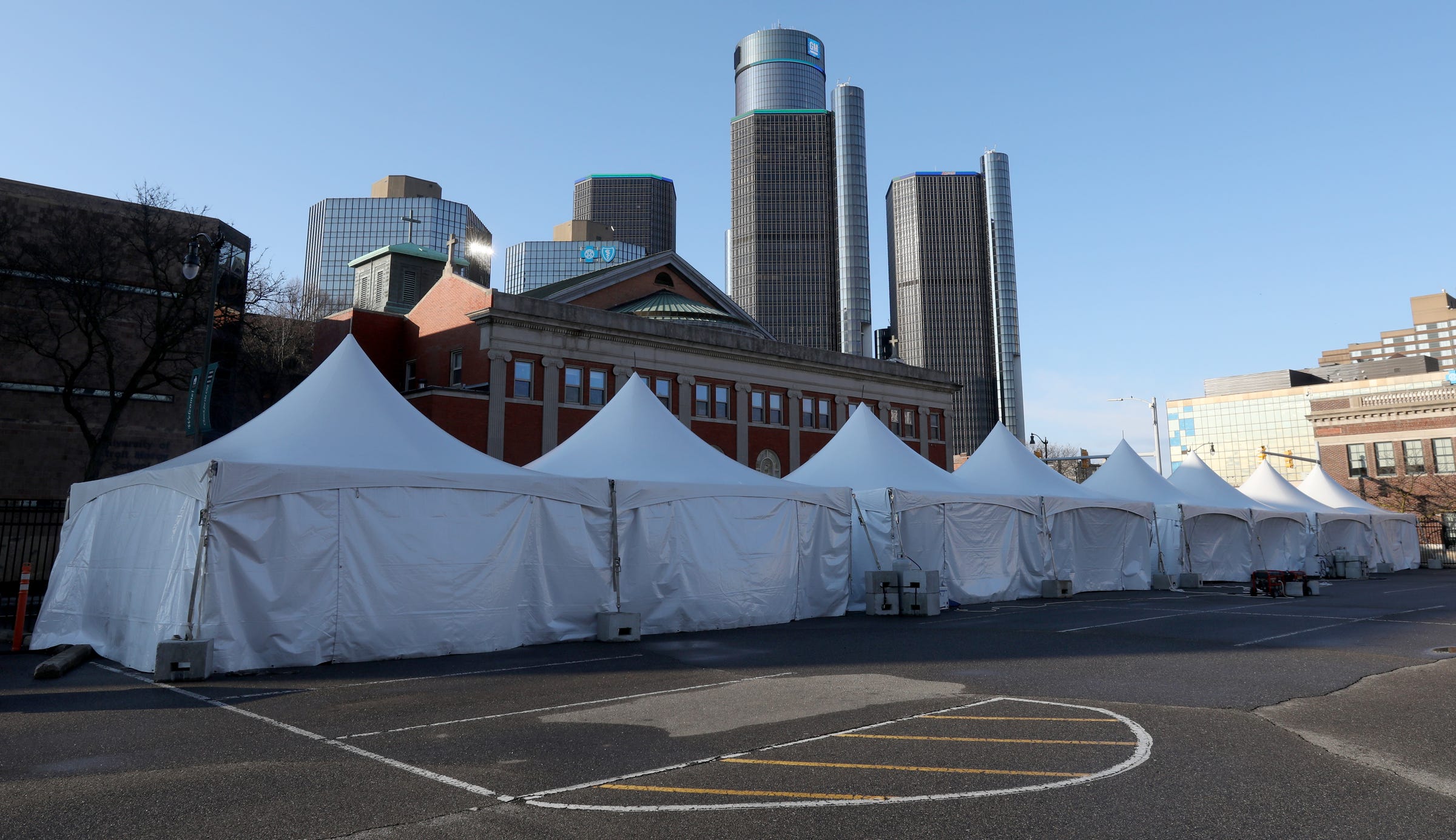 Large white tents for the homeless to sit, get warm and eat their breakfast or lunch handed out to them at the Pope Francis Center in Detroit, Michigan on April 9, 2020.
With the University of Detroit Mercy School of Law not in class due to the Coronavirus, the school allowed the center to use their parking lot for the tents and the portable shower.