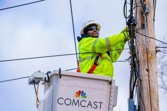 A Comcast technician maintains connections on a telephone pole. As more Tennesseans access work, school, news and government from home, internet technicians play an increasingly vital role in the COVID-19 response.