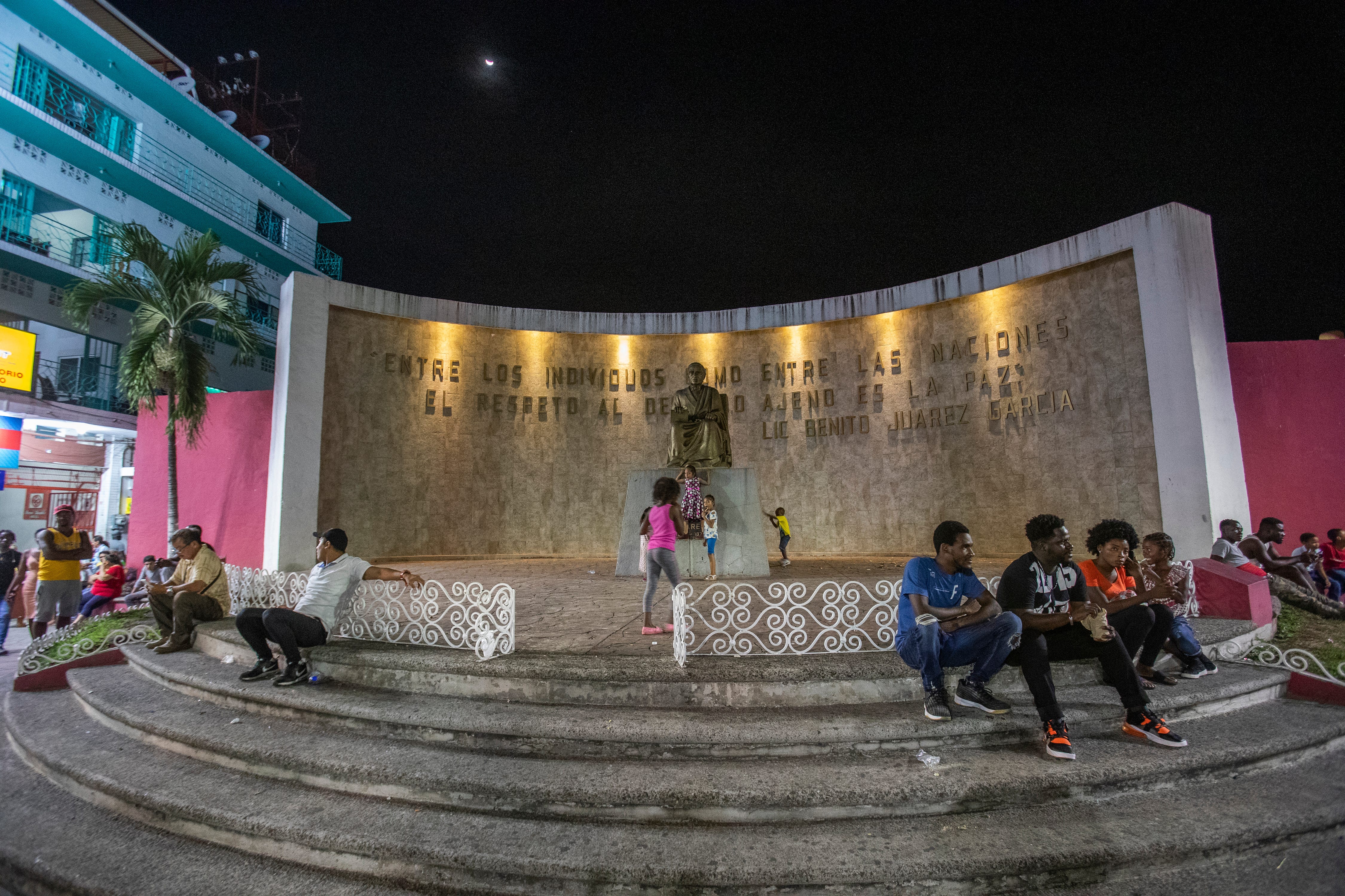 A plaza dedicated to Mexico's ethnic groups has become a meeting place for migrants from all over the world in Tapachula, Chiapas. In the background, the statue of Mexico's first indigenous, and most celebrated, president is seen in background.