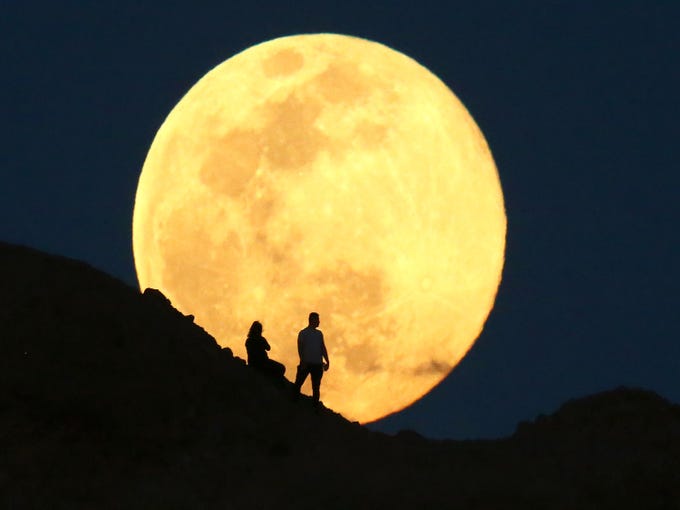 Apr. 7, 2020; Phoenix, AZ, USA; The supermoon, also known as the pink moon rises over the Papago Park Buttes, it is the biggest and brightest supermoon of 2020. The coronavirus has changed our lives as social distancing is in our lives