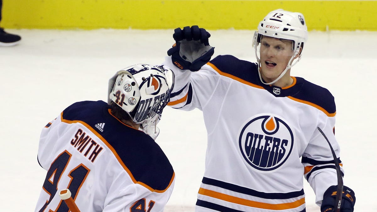 Edmonton Oilers goaltender Mike Smith (41) and center Colby Cave (12) celebrate after defeating the Pittsburgh Penguins.