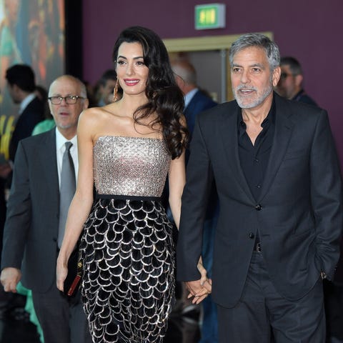 Amal Clooney and George Clooney attend the "Catch 