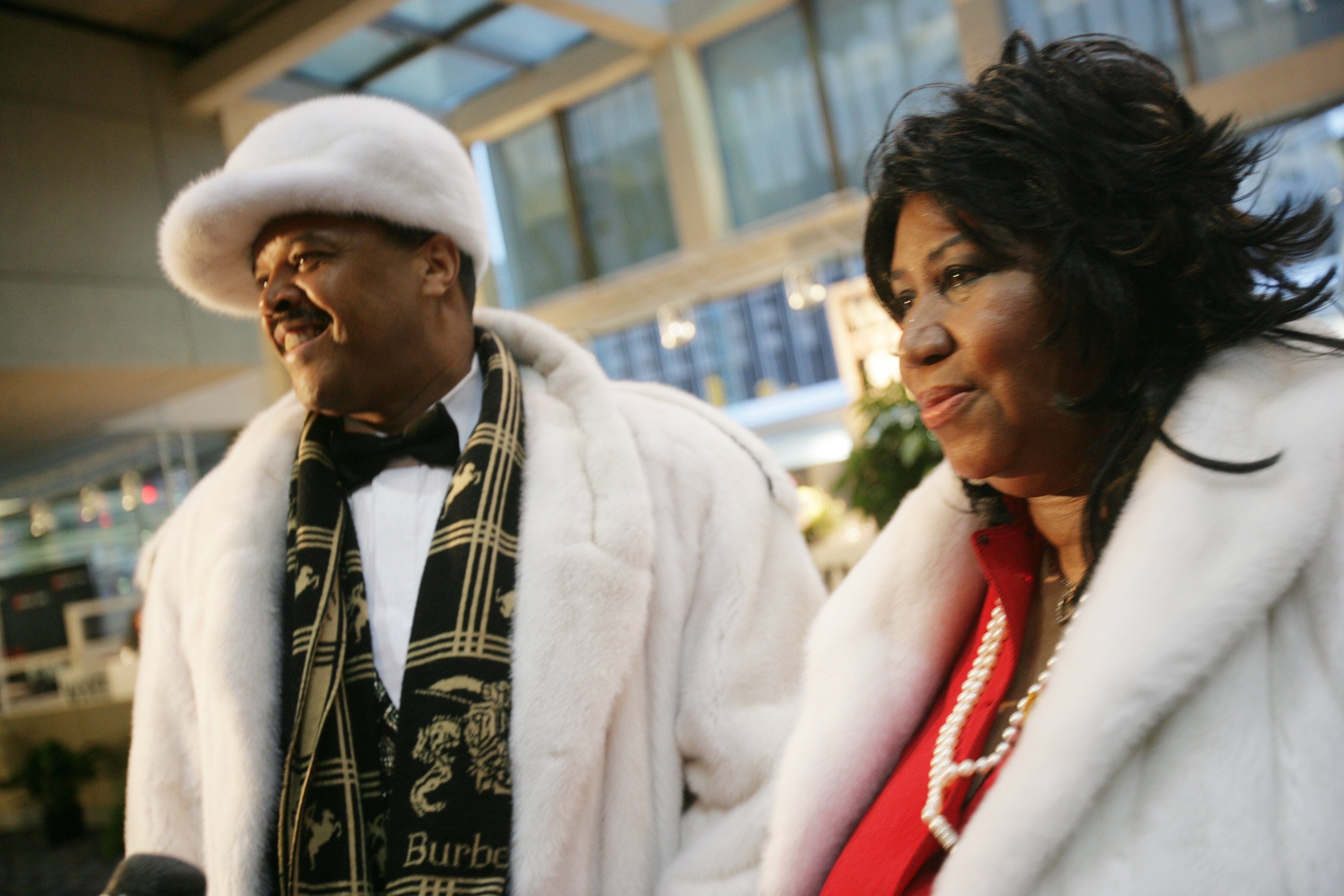 Detroit's Queen of Soul, Aretha Franklin, right, arrives Friday, January 13, 2006, at the North American International Auto Show Charity Preview with her date, Willie Wilkerson.