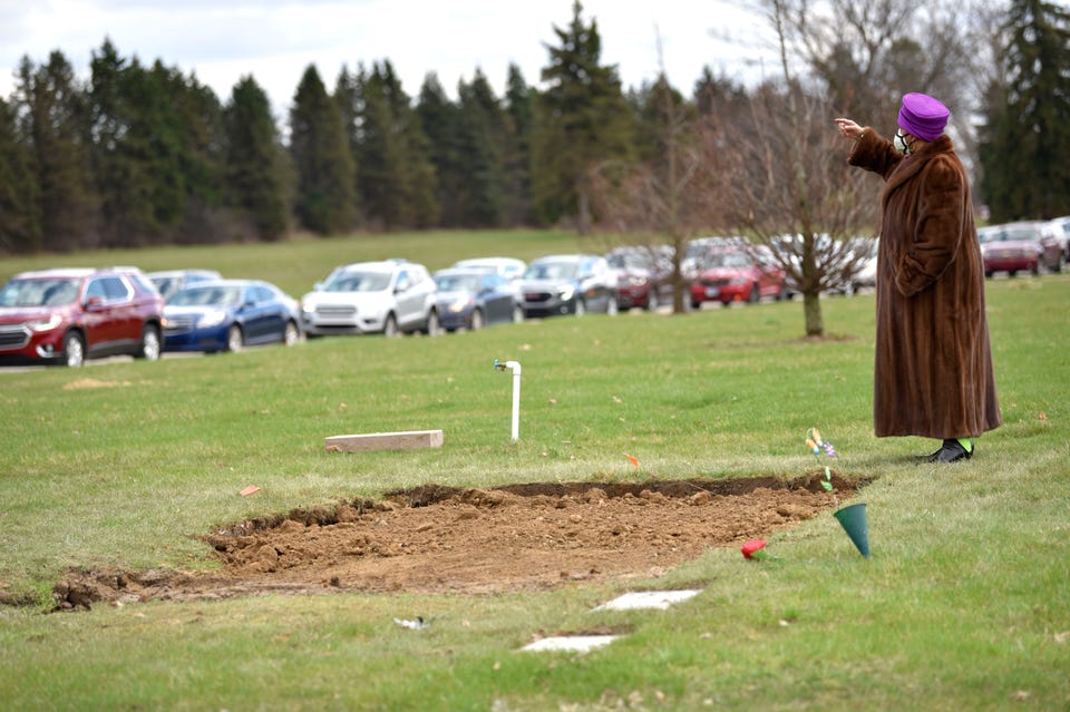 Cassandra Brown waves over a few close friends and family members to the grave site as others pay respects from their vehicle due to COVID-19. Cassandra Brown waves over a few close friends and family members to the grave site as others pay respects from their vehicle due to COVID-19.
