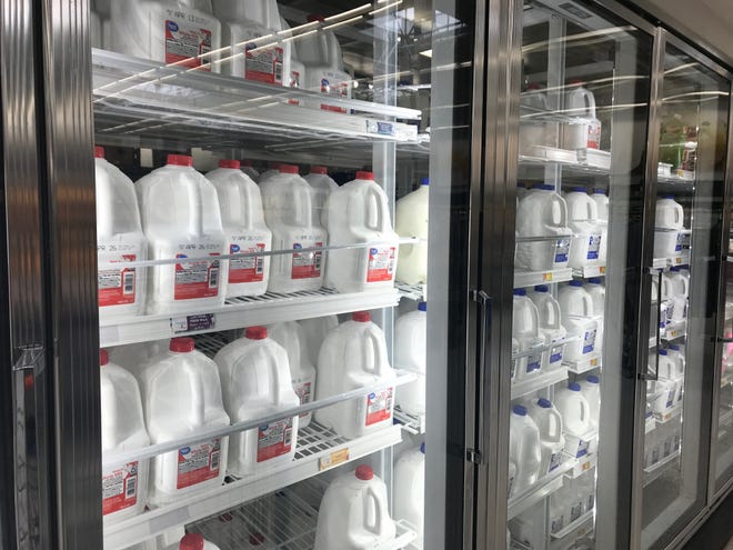 Milk stocks the refrigerators at an Indianapolis grocery store. Previous limits that had been placed on the amounts of milk that customers could buy, in response to panic-buying, are being removed.