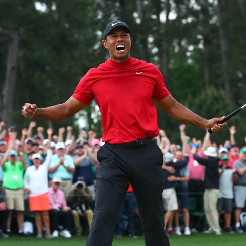 Tiger Woods celebrates after making a putt on the 
