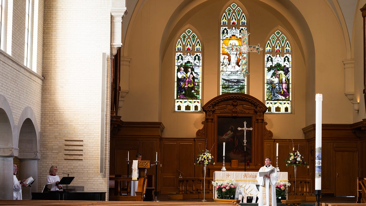 Rev. Nathan D. Pipho gives an Easter message to an empty church at Trinity Lutheran Church on Saturday, April 11, 2020. The service was videotaped and will be broadcast to parishioners on Easter Sunday.