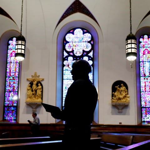 A church member prays during a Good Friday service