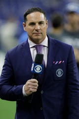 Former Michigan and NFL kicker Jay Feely, here as an NFL sideline reporter for CBS, has passed on the importance of community service to his four children.