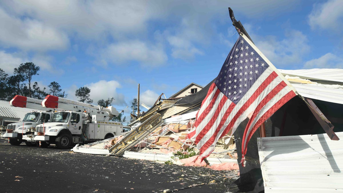 A tattered American flag hangs on the partially destroyed former Soso Elementary School building after a tornado touched down on Sunday, April 12, 2020.
