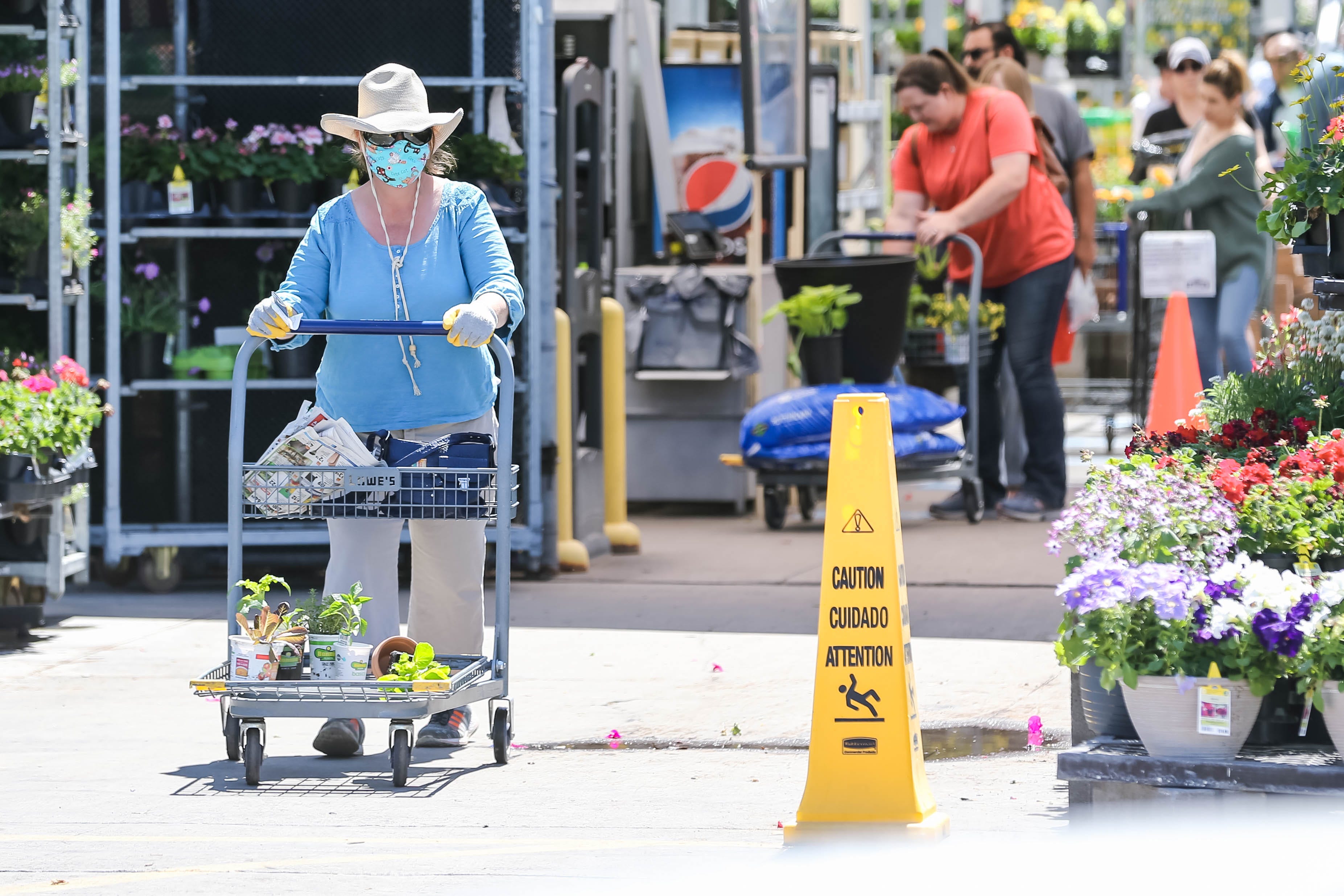 Shoppers wear masks and gloves while at Lowe's in Las Cruces on Saturday, April 4, 2020.