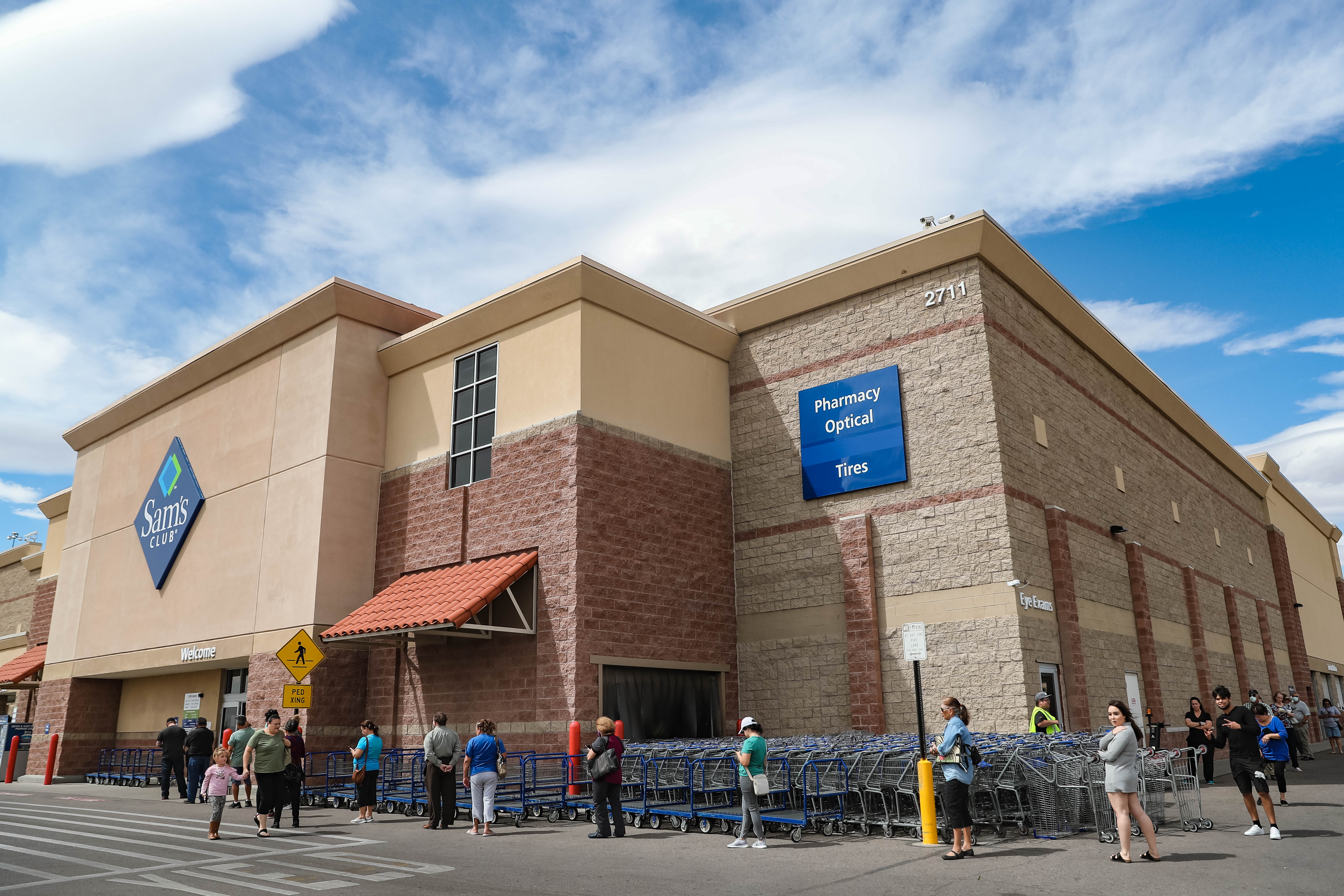 Dozens wait in a line, spread six feet apart, to shop at Sam's Club in Las Cruces on Wednesday, April 1, 2020.