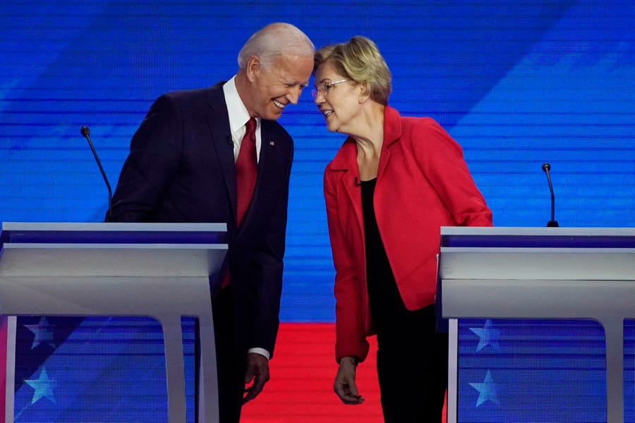 Former Vice President Joe Biden, left and Sen. Elizabeth Warren, D-Mass., talk Thursday, Sept. 12, 2019, during a Democratic presidential primary debate hosted by ABC at Texas Southern University in Houston.