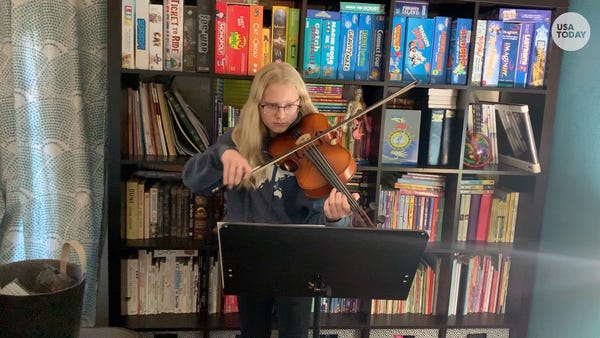 8th grader Piper Allen practices her viola at home