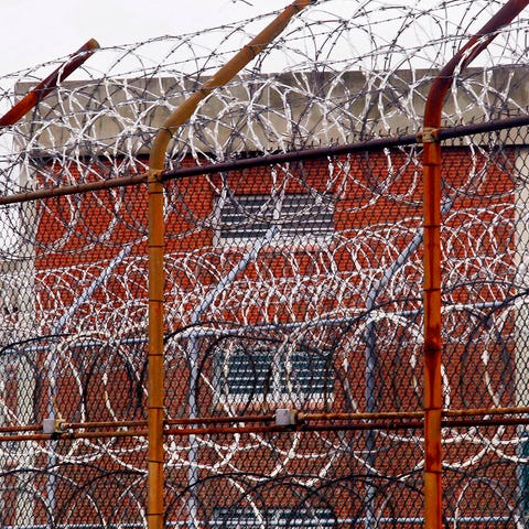 A security fence surrounds inmate housing on the R