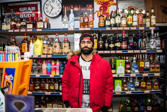 Karmvir Singh Gill manages liquor sales at Beadle Lake General Store on Wednesday, April 15, 2020 in Battle Creek, Mich. As nonessential businesses in Michigan close to slow the spread of COVID-19, liquor stores remain open so long as they also sell groceries, medical supplies or other essential products like toilet paper.