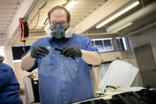 Technician Cory Elsarelli manufactures face shields inside the prototype lab at Mahindra's North American Technical Center in Troy on April 15, 2020. The shields are given to first responders to help provide protection when treating patients with COVID-19.