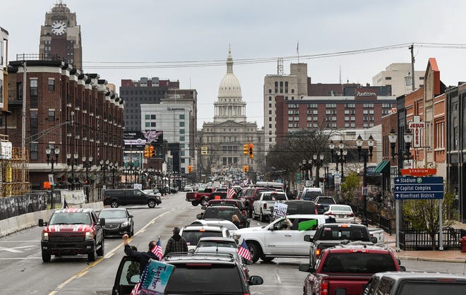 Demonstrators rally near the Michigan State Capitol in downtown Lansing, against Michigan Gov. Gretchen Whitmer's stay-at-home order Wednesday, April 15, 2020.