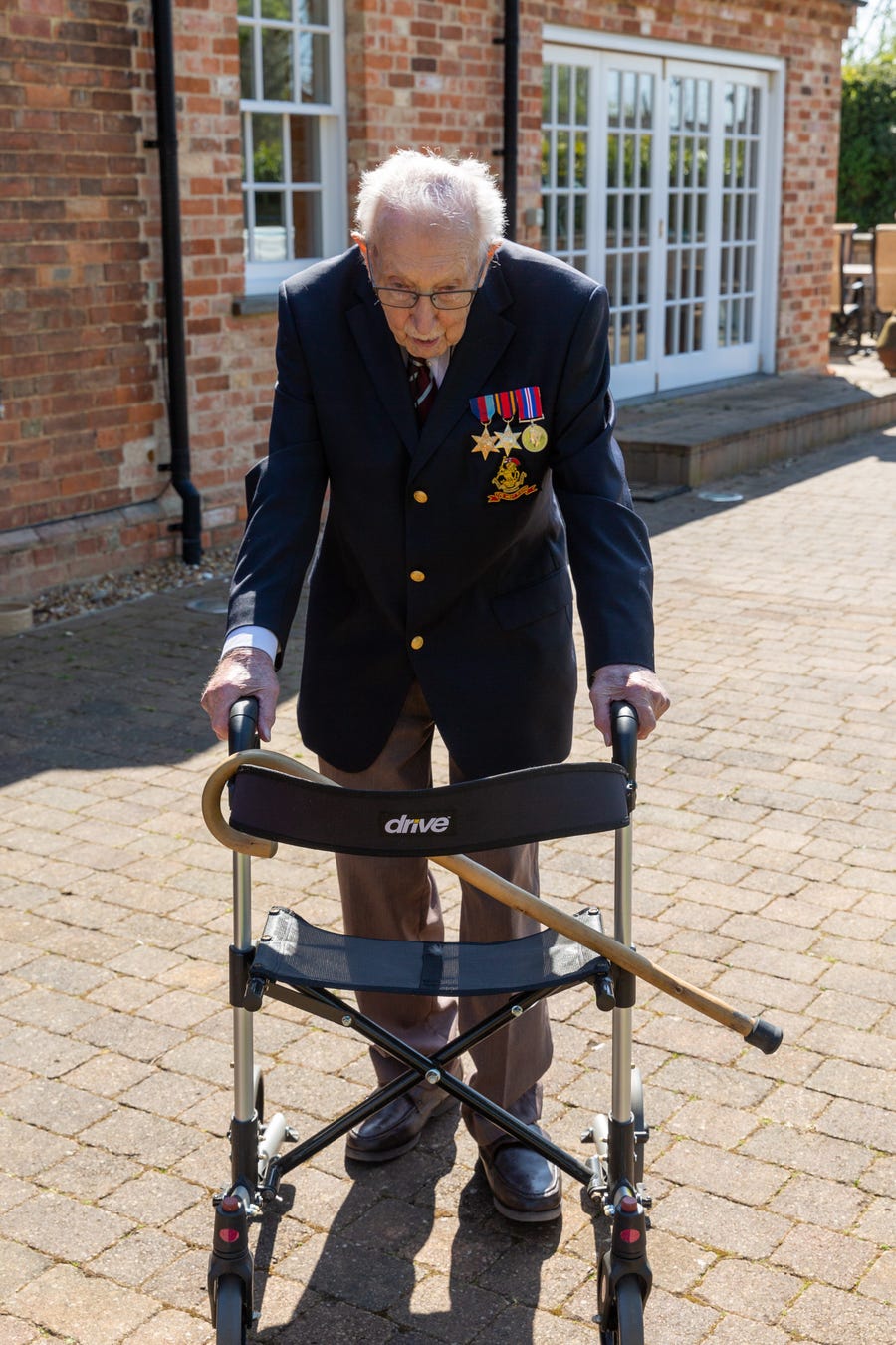 Tom Moore, 99, is doing laps around his garden to raise money for Britain's NHS.