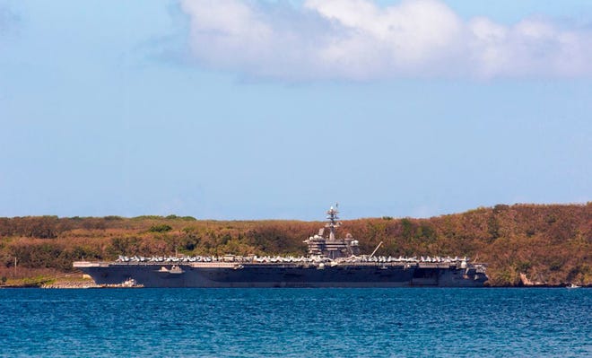 The aircraft carrier USS Theodore Roosevelt is docked at Naval Base Guam in Apra Harbor on April 10, 2020. - At least 416 sailors aboard the aircraft carrier, or 8.6 percent of the ships crew of 4,800, have tested positive for the novel coronavirus, with the numbers increasing daily. according to news media reports. (Photo by TONY AZIOS/AFP via Getty Images/TNS)