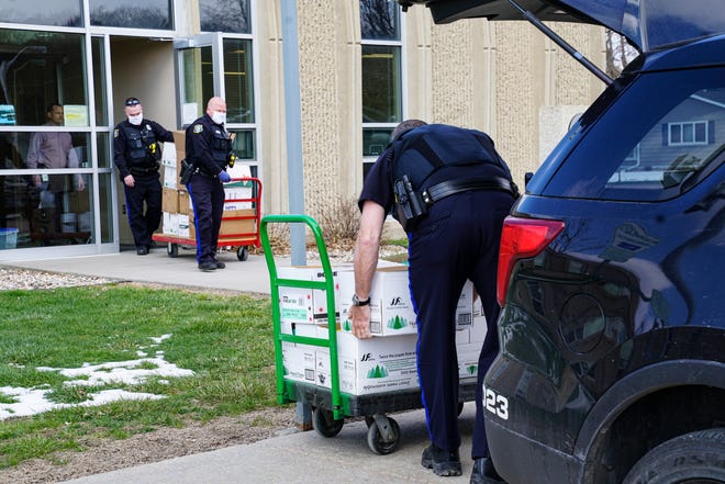 Sioux Falls police officers load boxes of cleaning supplies donated by the Sioux Falls School District this week to help support officers working during the coronavirus pandemic.