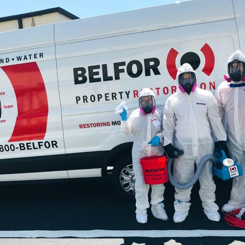 BELFOR crew in personal protective equipment.