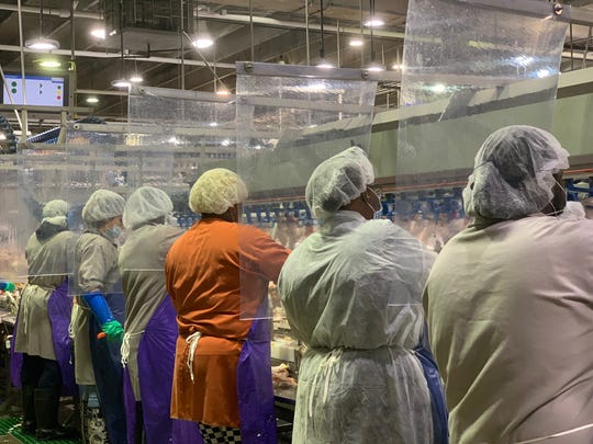 Workers are separated by sheeting at a Tyson Foods plant in Camilla, Georgia.