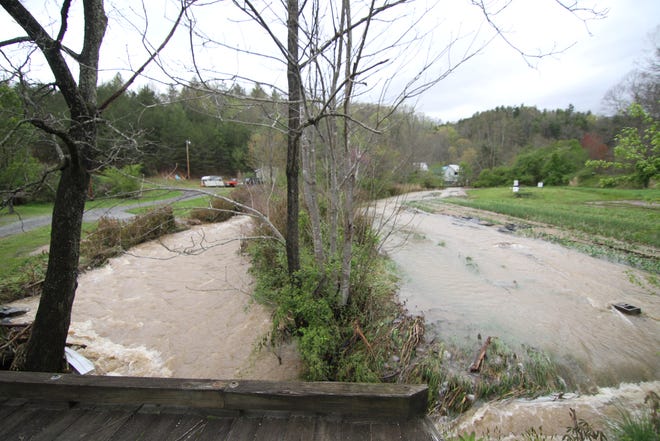 The view from a bridge beside Root Bottom Farm early April 13 shows how the East Fork of Bull Creek (left) jumped the bank and washed through the farm's strawberry patch and garlic field.