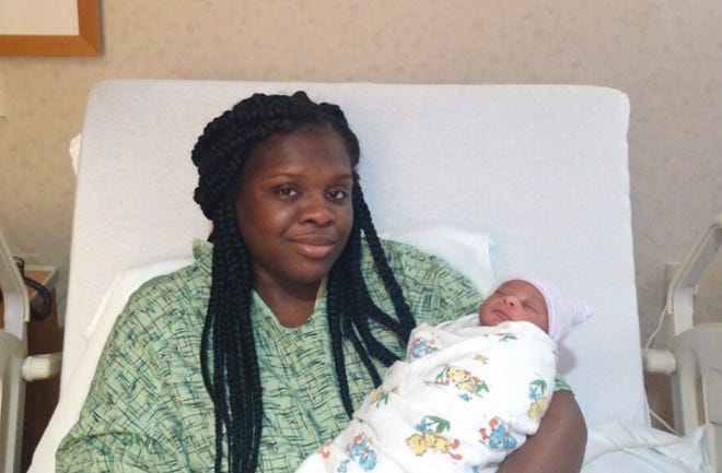 Shaquelley Taylor, 30, with her day-old son, Caleb.