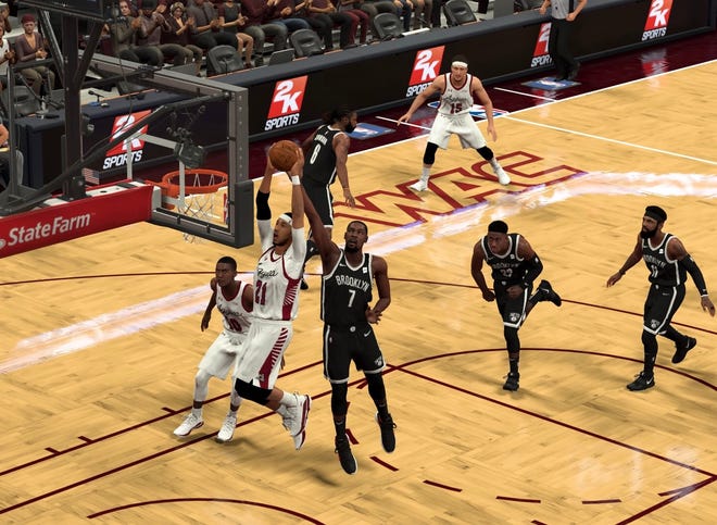 New Mexico State senior Trevelin Queen goes up for a dunk in an NBA 2K20 simulation.