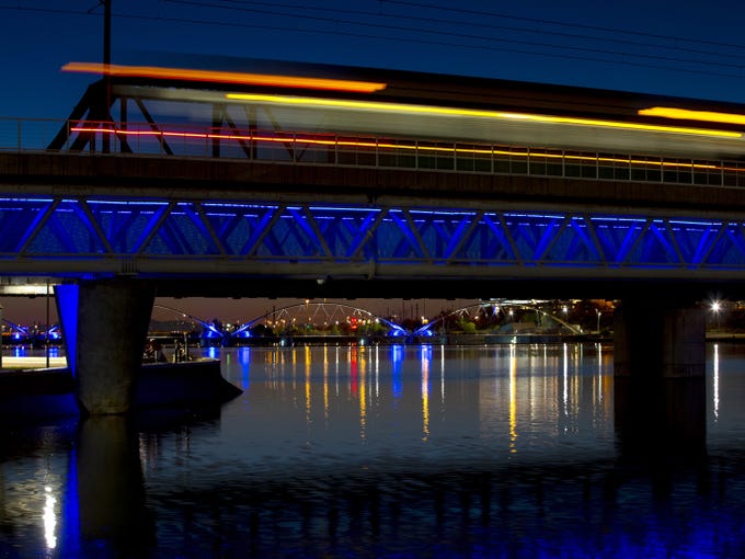 Light rail runs over blue tracks in Tempe on April 16, 2020.