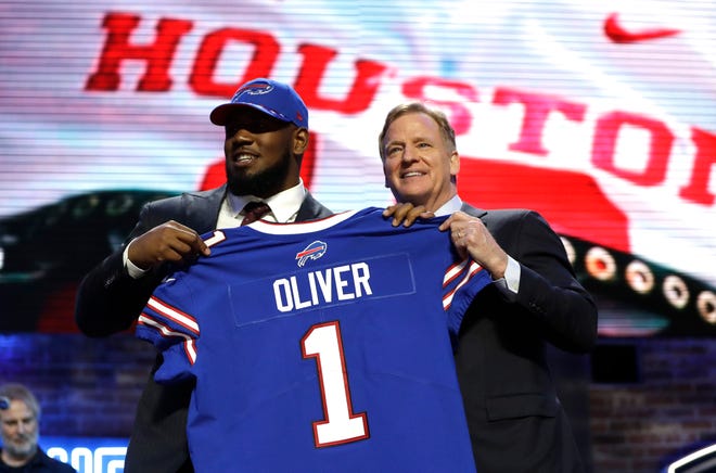 Houston defensive tackle Ed Oliver poses with NFL Commissioner Roger Goodell after the Buffalo Bills selected Oliver in the first round at the NFL football draft, Thursday, April 25, 2019, in Nashville, Tenn. The 2020 NFL Draft begins Thursday, April 23, and will be conducted virtually.