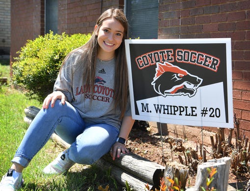 Morgan Whipple of the Lady Coyotes soccer team in front of her home decorated with school spirit.