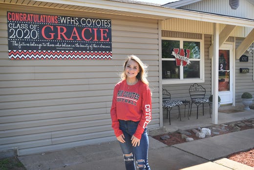 Wichita Falls High School softball player Gracie Dunn in front of her home decorated with school spirit for the senior.