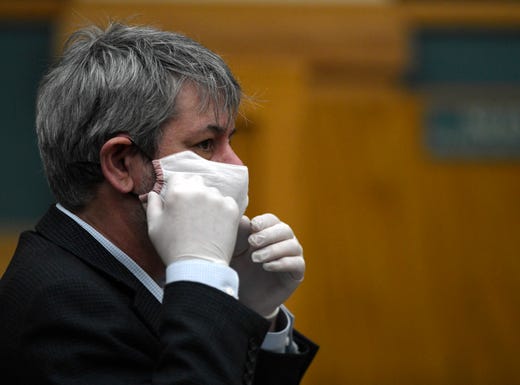 Texas A&M-Corpus Christi's Philippe Tissot puts on his face mask during the daily coronavirus press conference, Friday, April 17, 2020, at City Hall. Tissot gave a presentation with Chris Bird. 