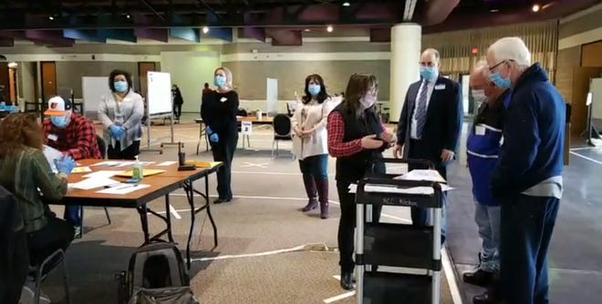 Poll workers begin the recount of the Racine school district's $1 billion referendum, which passed by a five-vote margin.