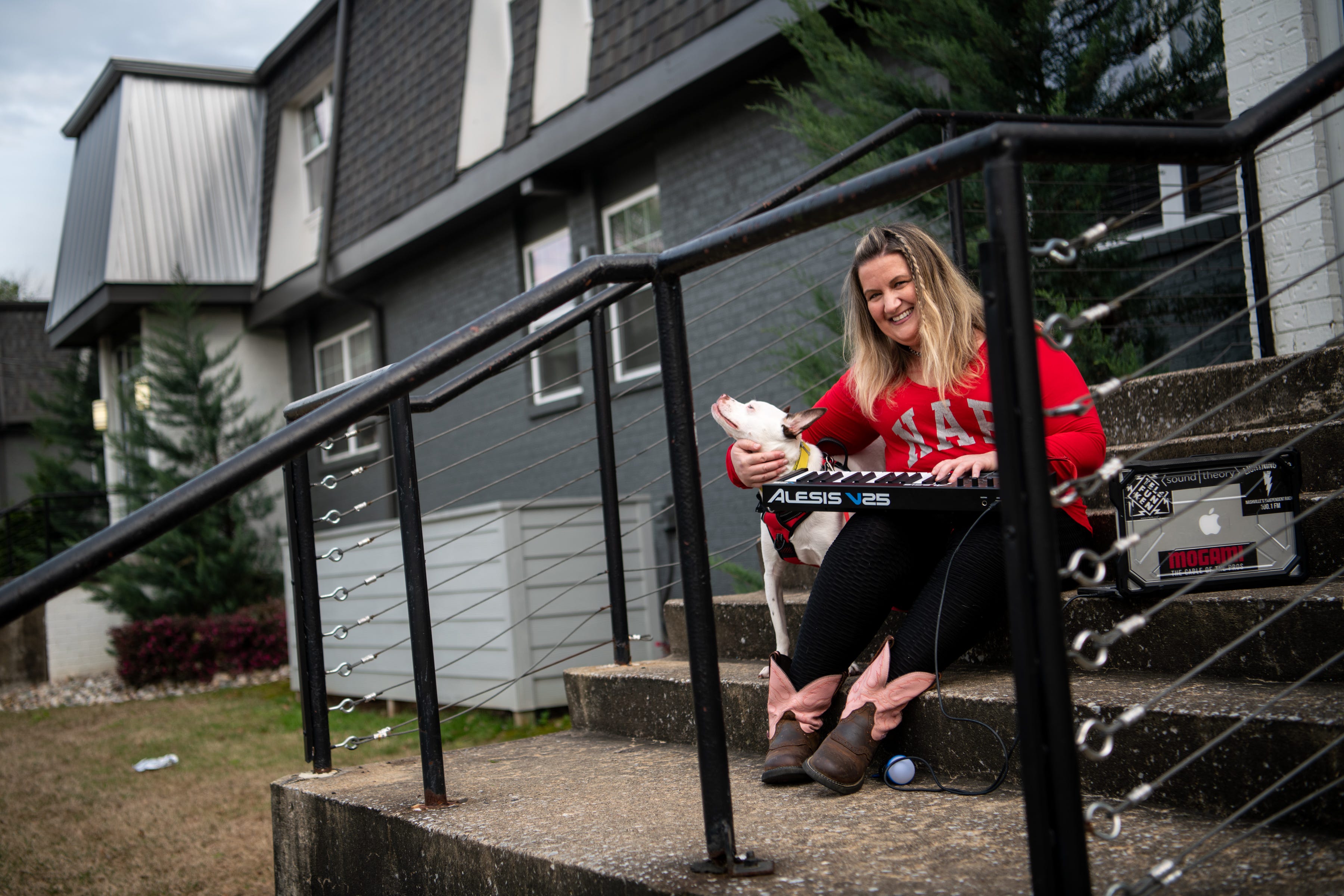 Stefani Matranga Scovolo, a musician, educator and real estate agent, sits with her dog, Stella, outside her apartment in Nashville on Friday, April 17, 2020.