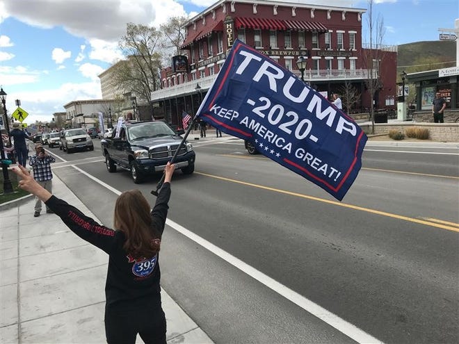 Residents gather at the state capitol in Carson City on Saturday, April 18, 2020, to protest Gov. Steve Sisolak's statewide shutdown. The protest was to promote reopening businesses.