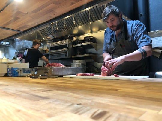 Portland chef Ryley Eckersley, whose restaurant Quaintrelle has shifted to takeout only, preps chicken fried steak in his small kitchen, where he says it's nearly impossible to stay six feet away from his cooks.