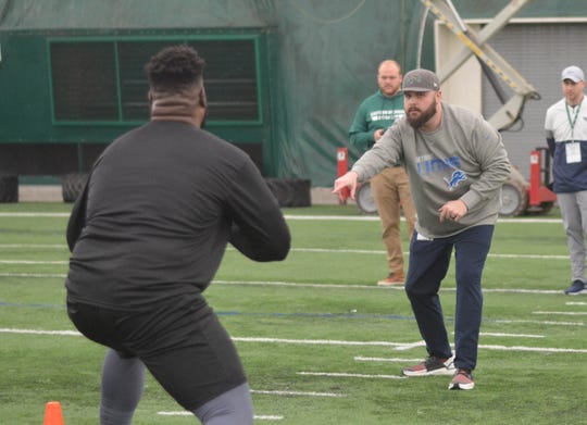 Ron Miles, the Lions' college scouting coordinator, works Eastern Michigan's pro day last month.