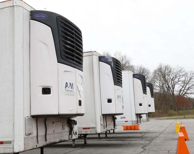 Refrigerated tractor trailers parked at James Baird State Park in LaGrange on April 20, 2020.  Signs near the trailers state that they are at the park as part of a staging area for COVID-19 response.  