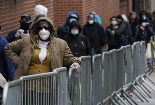 People wait in line for a coronavirus test at one of the new walk-in COVID-19 testing sites that opened at the located in the parking lot of NYC Health + Hospitals/Gotham Health Morrisania in the Bronx Section of New York on April 20, 2020.