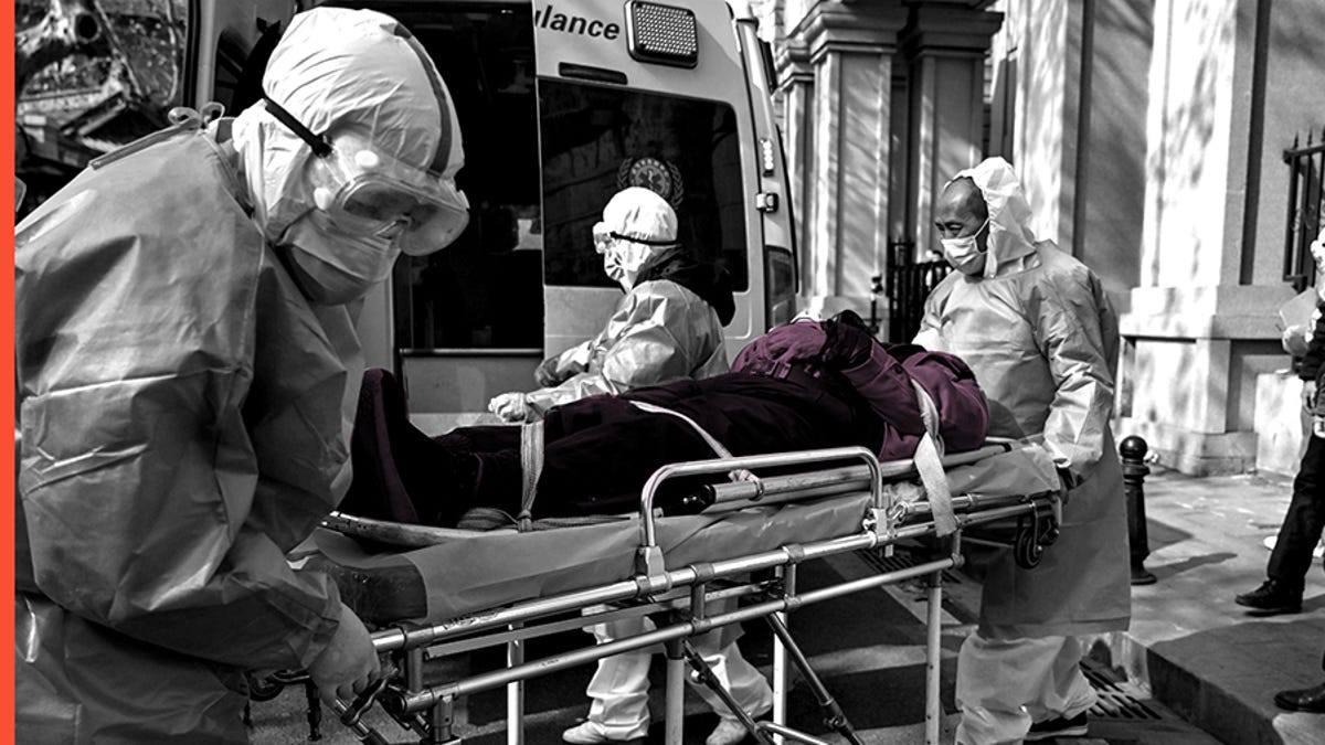 Medical staff in protective clothes are seen carrying a patient from an apartment suspected of having the virus in Wuhan, in Hubei province on January 30, 2020.